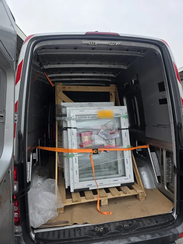 Windows on a pallet, strapped down for the journey